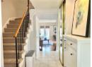 Stairway featuring tile patterned floors and a textured ceiling