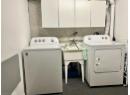 Laundry area with washer and clothes dryer and cabinet space