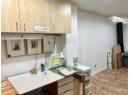 Kitchen with a textured ceiling and light countertops