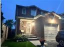Traditional-style home featuring brick siding and an attached garage