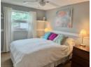 Bedroom featuring carpet, a textured ceiling, and a ceiling fan