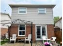 Rear view of property with brick siding, a patio area, and a deck