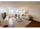Living area with dark wood-style floors and recessed lighting