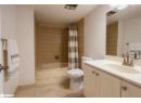 Full bathroom featuring shower / tub combo, vanity, and light tile patterned floors