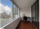 Office space featuring dark wood-type flooring and a skyline view
