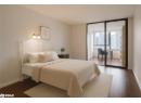 Bedroom with dark wood-style flooring and floor to ceiling windows