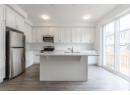 Kitchen featuring appliances with stainless steel finishes, white cabinets, and dark wood-type flooring