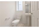 Half bath featuring baseboards and light marble finish flooring