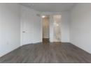 Unfurnished bedroom featuring dark wood-type flooring and a spacious closet