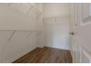 Walk in closet with wood finished floors