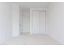 Unfurnished bedroom featuring light carpet and a closet