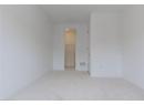 Empty room with light carpet and baseboards