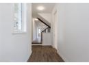 Hall featuring dark wood-style floors and stairs