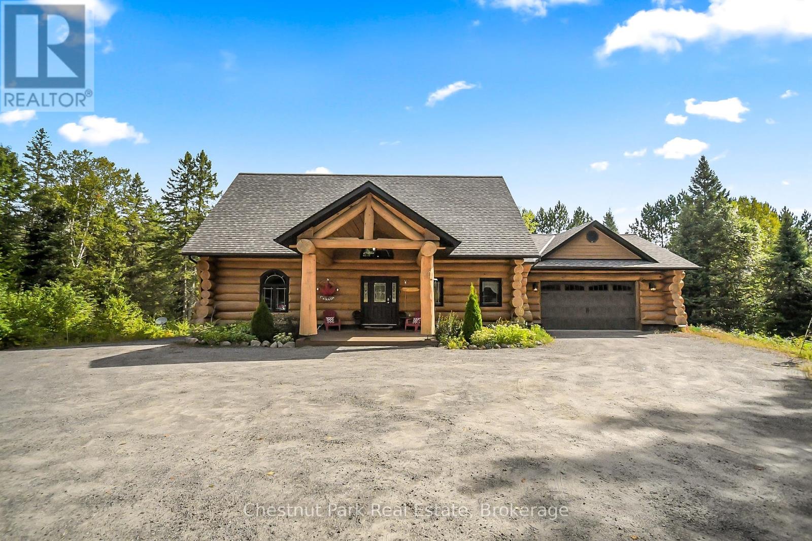Tucked away on a 2.5 acre escape, this custom-built Scandinavian hand scribe log home welcomes you with its soul-soothing blend of rustic elegance and modern comfort. Despite its incredible privacy, this home is in the vibrant community of Huntsville, Muskoka, surrounded by natural beauty, this one-of-a-kind retreat offers a life where every day feels like a getaway.  Masterfully crafted by Little Log Homes in 2020 for the current owner, this remarkable property showcases massive hand-hewn logs, soaring ceilings, and an impressive log entry covered porch that immediately sets the tone for the craftsmanship within. Huntsville is the largest community in Muskoka offering charming shops, restaurants, golf courses, live theatre & access to Arrowhead Park. Only 5 years old & meticulously maintained, this home is a rare opportunity to own a truly one-of-a-kind log home retreat.  1 minute to the Big East River, for casting a fishing line, or enjoying a peaceful paddle, and just minutes for a stroll alongside the Big East River to the historic Dyer Memorial. This property invites a slower pace and a deeper connection to nature. A truly unique home that blends character, comfort & the spirit of the outdoors.  Bungaloft floor plan with over 1800 sqft of living space on the main level second level.  Main floor primary bedroom with 5pc ensuite bath & walk-in closet with 2 guest rooms, office & 3pc bath on second level.  2 pc powder room & laundry on mail level with There are many extra features to this home to name a few; quartz counter tops, hot water on demand, central vac, central air, oversized detached garage with extra high garage door, Generlink generator system to run entire home, 10' main floor ceilings, 9' second level ceilings, ICF foundation, 46' back covered decking overlooking natural treed surroundings.  Full walk-out basement with additional living space (663.50 sqft approx) offering in-law suite capability with kitchenette, 3 pc bath with large family room. (id:48254)