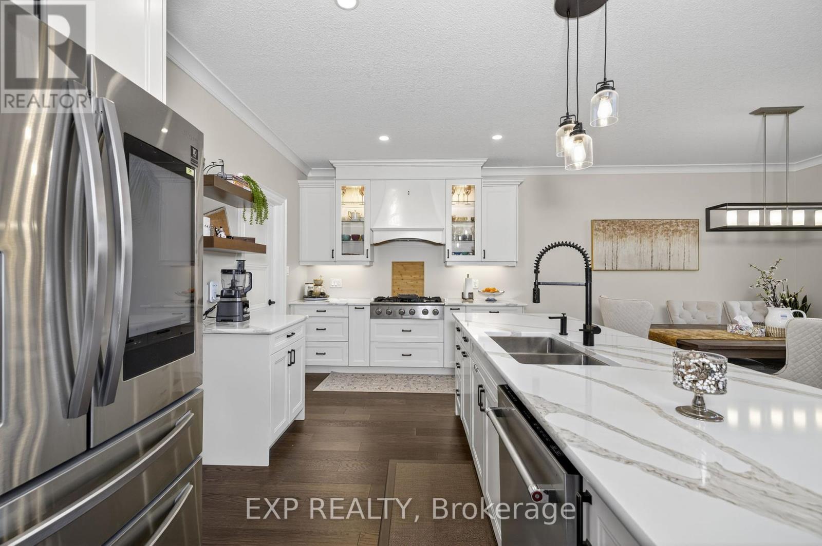 Welcome to this one-of-a-kind 1.5 story Bungalow located in the desirable community of Lucan, just a short 15-minute drive to London. Offering over 3,400 sq. ft. of total finished living space, this home perfectly blends luxury, function, and design. Step into a sun-filled living room featuring soaring 22-ft cathedral ceilings and a dramatic 10-ft fireplace wall. The heart of the home is a stunning chef's open-concept kitchen with High-end Appliances, upgraded cabinets, countertops, and a large island, complete with a walk-in pantry, perfect for entertaining and everyday living. The main level includes a spacious primary bedroom with a luxurious ensuite featuring a jetted tub, glass shower, and a large walk-in closet. A second generously sized bedroom (Presently used as a Den/Office space) with its own walk-in closet and a full 3-piece bathroom is also located on this level.  Upstairs, you'll find two additional bedrooms, each with walk-in closets, along with another full bathroom, making this layout perfect for families or multi-generational living. The fully finished basement (2022) adds incredible value, featuring a large family room, a rec area with all-over Pot lights, 2 additional bedrooms, and another full bathroom. Extras - Water heater and water softener owned. Built-in Gas stove, Gas Dryer for low electricity cost. Gas line outlet in the backyard for the BBQ, Window coverings, Wet Bar rough-in in the basement, Central vacuum and equipment. Located on a quiet street in a family-friendly neighborhood, this rare opportunity is not to be missed! (id:48254)