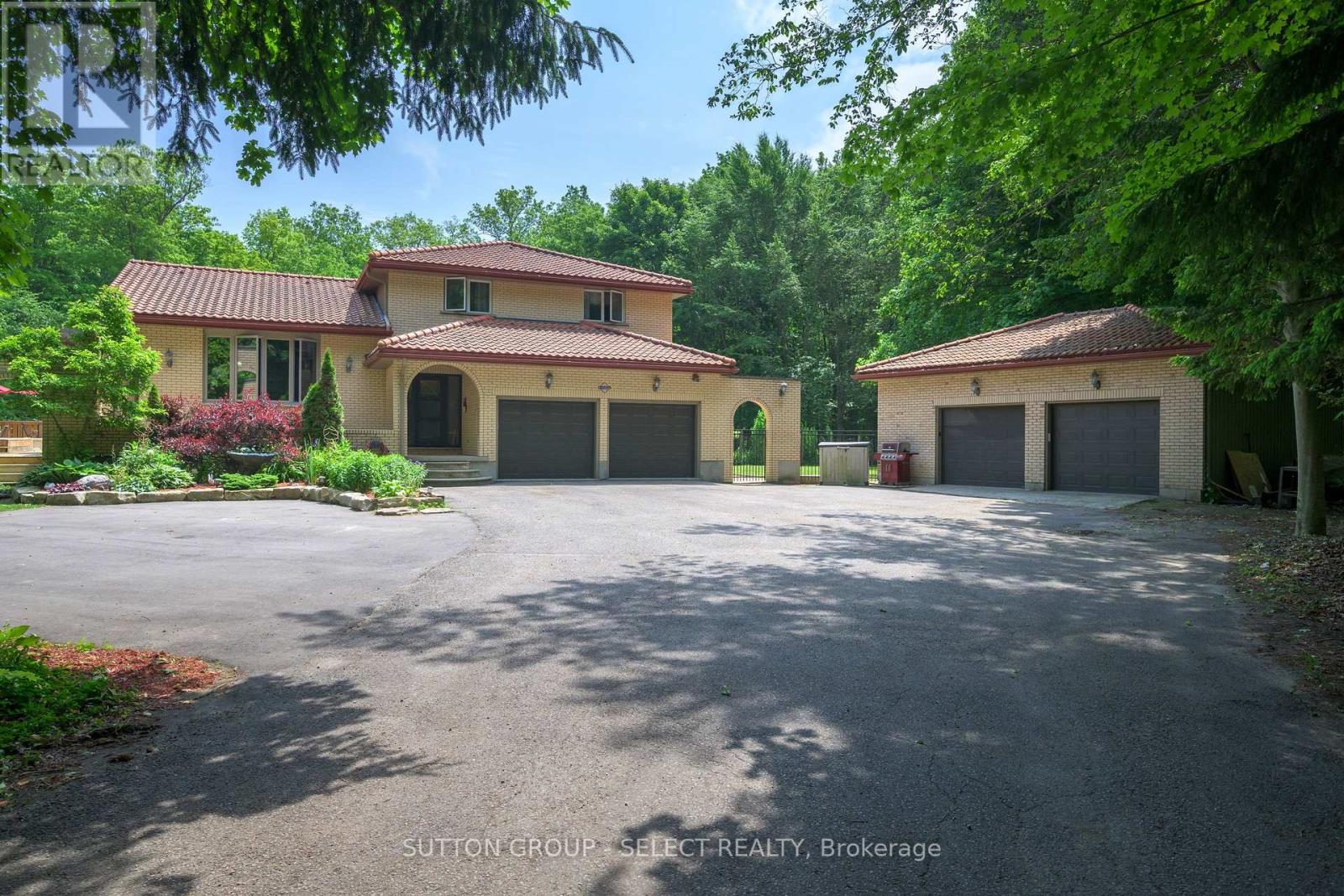 Welcome to Your Private Oasis Just Minutes from London! This beautifully maintained split-level home, built in 1988, sits on nearly three acres of private, treed, and landscaped grounds the perfect blend of serenity and convenience, just minutes outside of London.Step inside to discover an open-concept main floor featuring a renovated kitchen footprint, ideal for entertaining and everyday living. The spacious family room boasts a cozy fireplace and built-in bar, creating the perfect spot to relax or host guests.This versatile home offers 4+1 bedrooms, including a generous primary bedroom with ensuite, and a total of 4 bathrooms. The lower-level apartment with a separate entrance through the garage is ideal for multi-generational living or rental income. Additional suite options include the garage. Enjoy summers in style with a large wrap-around deck, above-ground pool, and a fabulous outdoor kitchen an entertainers dream! Extras include live edge surfaces and trim, updated mechanicals, a 731 sf heated workshop, dog kennel, and 400sf insulated shed everything you need for country living with city convenience.Don't miss this rare opportunity to own a spacious, move-in-ready home with incredible outdoor living and income potential all in a tranquil, park-like setting. (id:48254)