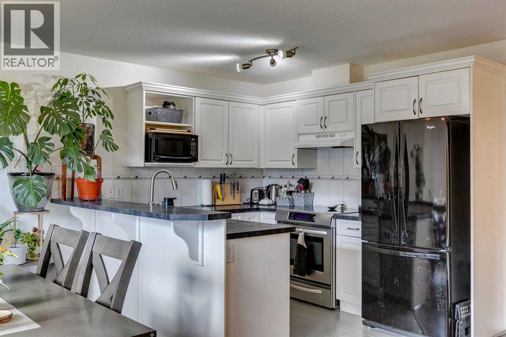 51 Spring Meadows Bay, Okotoks, Alberta  T1S 2G8 - Photo 6 - A2259710