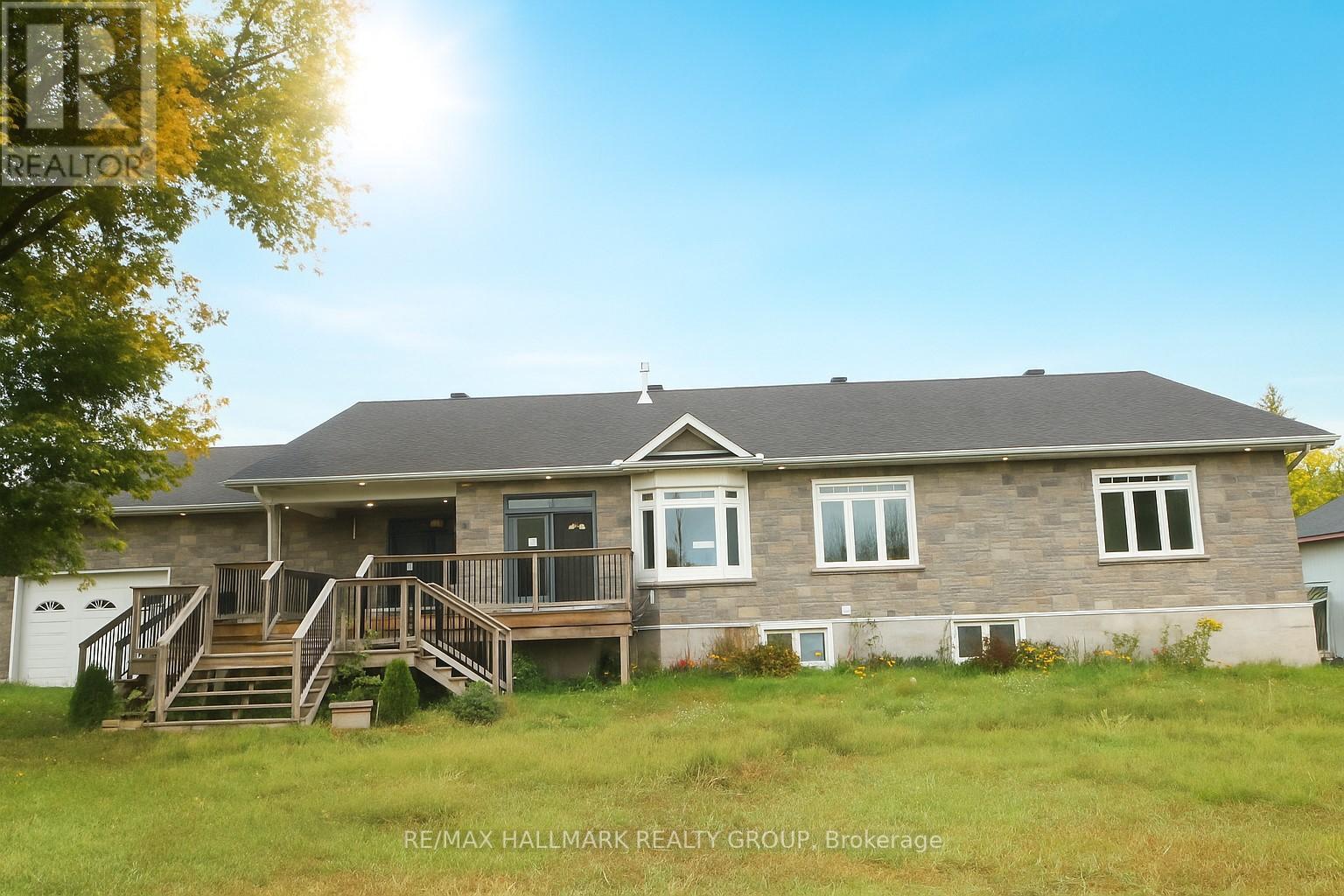 Here is an opportunity for an extended family, someone looking for income, that could use a variety of outbuildings, all with an approx 41 acre lot and views of Eadys Lake! This spacious bungalow with oversized attached garage (fits up to 4 vehicles), and large lot with multiple outbuildings offers a framed lower level walkout basement. Main floor features open-concept living/dining with central gas fireplace, large kitchen with island and deck access, main floor laundry, and spacious tiled entry. Primary suite includes walk-in closet, screened-in porch, and cheater ensuite with whirlpool tub and open shower. Two additional bedrooms, including one with unfinished 4-pc bath (fixtures on site). Laminate flooring throughout. Basement is framed and roughed-in for secondary suite with wiring and plumbing started. Furnace (2018), on-demand hot water, some smart wiring. Includes 2 detached garages, 2 sheds, and gated access to second dwelling and back lot.  The second bungalow dwelling is a 2-bedroom structure with electric heat, no power (at this time) and requires significant repairs. Loads of potential for the right buyer. Property sold as-is under Power of Sale (id:48254)