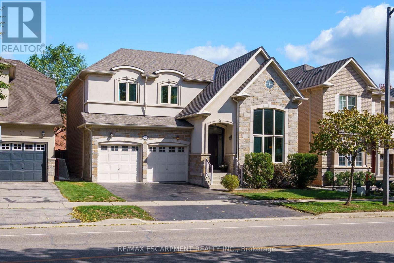 Welcome to this beautifully upgraded home in desirable Lakeshore Woods! Finished from top to bottom, this stunning property offers over 4,200 sq. ft. of luxurious living space, featuring 4 spacious bedrooms, 5 baths, a main floor den, and an incredible finished basement. Hardwood floors throughout the main level and a cathedral ceiling in the liv. rm, where a large picture window fills the space with natural light and overlooks greenspace. The renovated 2-piece powder room and large upgraded kitchen boast stainless steel appliances, including a built-in dishwasher, microwave, gas stove, and ice-making fridge. Nine-foot ceilings enhance the home's sense of openness and airiness. The bright, oversized family room features a gas fireplace and pot lights throughout. The main floor office is ideal for today's work-from-home lifestyle, while the renovated laundry/mudrm offers a stackable washer/dryer and convenient garage access. Solid wood staircase leads to the upper level, where you'll find a spacious principal suite with a sitting area, a gorgeous 5-pc reno'd ensuite with heated floors, under-cabinet lighting, illuminated mirror, glass shower, double sinks, and a freestanding slipper tub. The suite also includes a generous w/i closet. 3 additional large bedrooms complete this level, bedrms 2 and 3 share a semi-ensuite, and bedroom 2 features its own walk-in closet. The finished basement is an entertainer's dream, with wet bar, custom built-in cabinetry, exercise area, games room, and multiple storage spaces including a cold room. Recent upgrades: new window panes throughout, reshingled roof, new A/C, new front door, exterior light fixtures, upgraded attic insulation, and pot lights throughout. The private, fully fenced backyard features multi-level decks. Ideally located within walking distance to the lake, Sheldon Creek Trail Park, Creek Path Woods, Shell Park, and Nautical Park, and just minutes to Appleby GO, highways, top-rated schools, shopping. Wow! Don't miss! (id:48254)