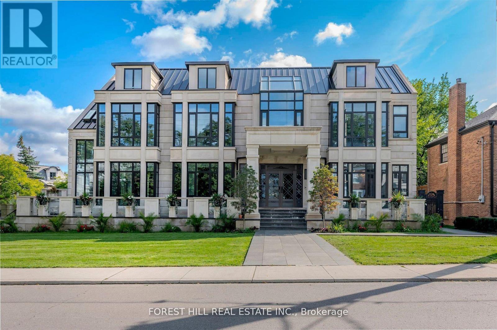 Welcome to 505 Russell Hill Road, an extraordinary custom-built residence in the heart of Forest Hill one of Canada's most prestigious neighbourhoods. Completed in 2023, this timeless limestone two-storey home sits on a prominent corner lot and offers over 9,100 sq. ft. of luxurious living space, complete with a built-in tandem 3-car garage and heated driveway. The bright, family-friendly layout features soaring floor-to-ceiling windows that flood the home with natural light. The open concept kitchen and family room feature heated floors throughout. Chefs kitchen with high end appliances and a secondary fry kitchen with sink and stove rough-in, Ideal for entertaining. The second level showcases a dramatic skylight and four spacious bedrooms, each with its own ensuite, including a primary suite with spa-inspired bath and generous walk-in closet. Elevator that services all floors. The finished lower level is designed for recreation and entertaining, featuring a 45 x 19 bar, nanny suite, rough-in theatre room, indoor swimming pool, hot tub, and rough-in for an additional bathroom.This is a rare opportunity to own a distinguished Forest Hill address, minutes away from the Kay Gardner Beltline Park and Trail - a unique part of Torontos parks and Ravines, and close proximity to Canadas most renowned private schools, including Upper Canada College (UCC) and Bishop Strachan School (BSS). *Please note. Power of sale. Sold as it is. (id:48254)