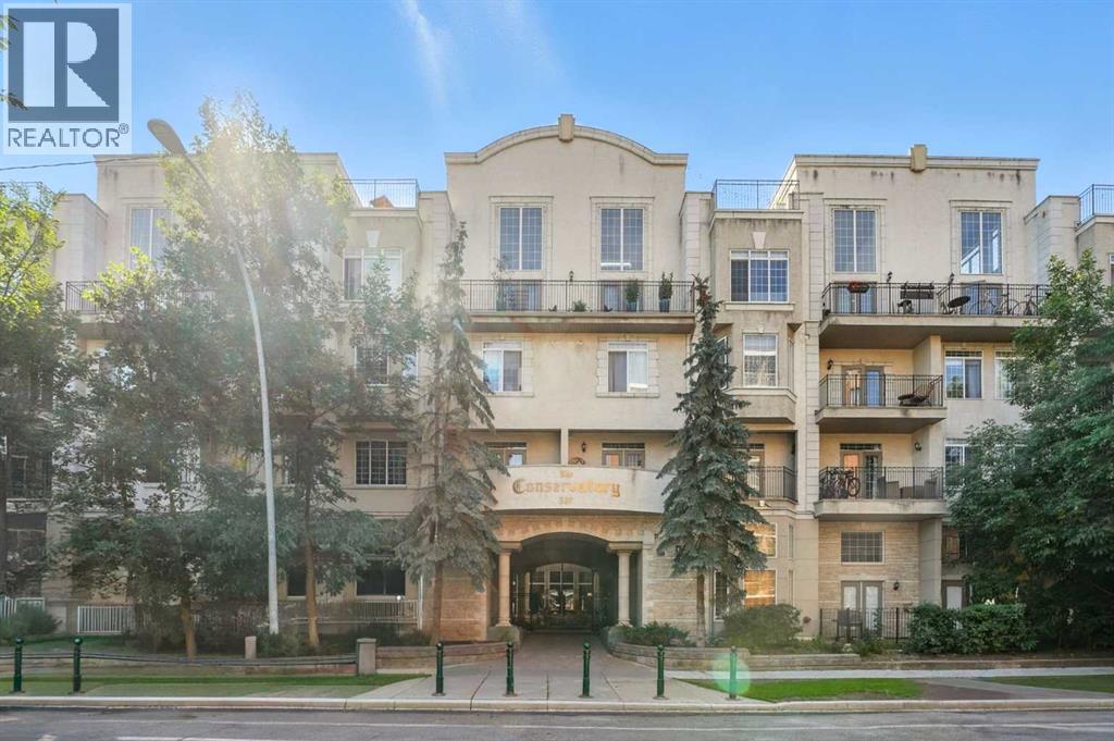 Welcome to The Conservatory, a prestigious gated complex that blends timeless architecture with modern convenience in the heart of Calgary’s Beltline. A serene courtyard with brick pathways, lush greenery and cascading fountains creates a tranquil setting just steps from downtown energy. This stylish home opens from the breezeway to a private entrance, offering an inviting layout perfectly suited for urban professionals and first-time buyers. Inside, soaring 9-foot ceilings and gleaming laminate floors create a bright, open atmosphere designed for easy living. The kitchen inspires culinary creativity with ample cabinet and counter space plus a large island ideal for casual gatherings. An adjacent living room with gas fireplace invites relaxation, while French doors extend the living space outdoors to a private balcony that encourages a seamless indoor/outdoor lifestyle. The primary bedroom is spacious with an oversized window that fills the room with natural light, while the four-piece bathroom separates the bedrooms for added privacy. A second bedroom adds versatility as a guest space, office, hobby space or home gym. In-suite laundry, underground heated parking and abundant storage further enhance daily ease. This quiet treelined street offers a peaceful retreat while keeping you connected to everything. Walk to Uptown 17th’s dining, shopping and nightlife, stroll to the Stampede grounds and MNP Sports Centre or commute easily with the nearby LRT station and downtown core within reach. Offering a blend of character, convenience and community, this bright and inviting condo is the ideal for those seeking both vibrancy and comfort. (id:48254)