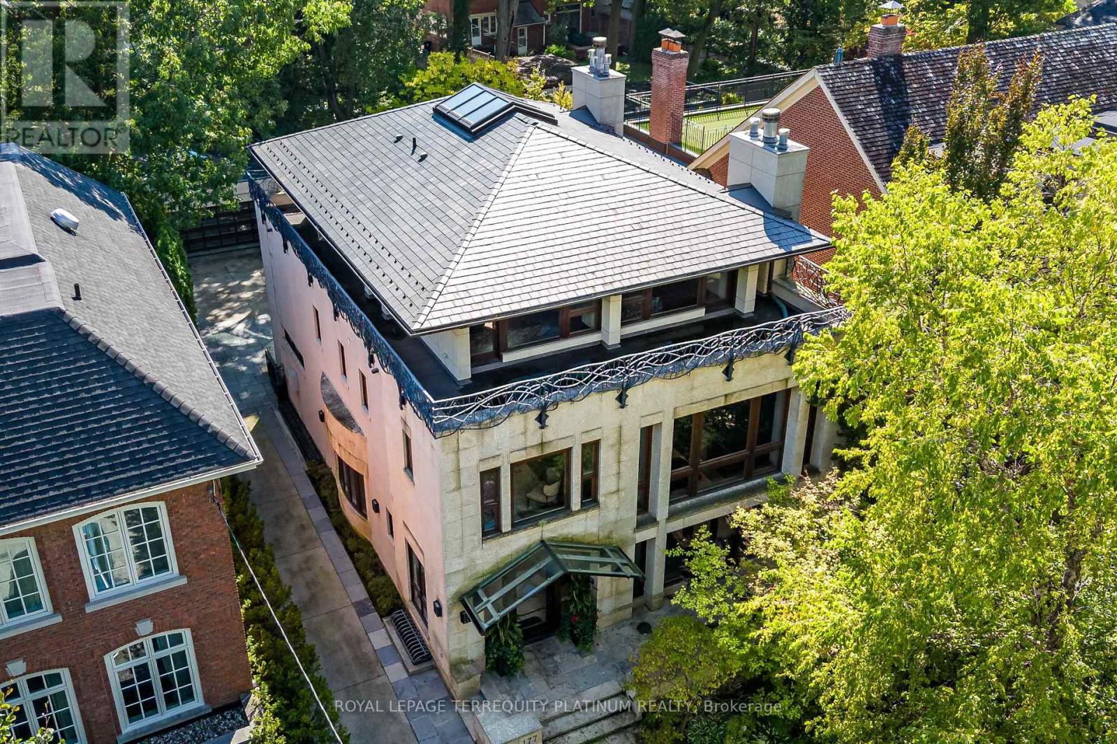An architectural tour de force by acclaimed Robert Le Blond, recipient of the 1990 Governor Generals Award in Architecture ("Head-Smashed-In Buffalo Jump" in Alberta, now a UNESCO World Heritage Site), this 20-year-young bespoke residence is a French Art Deco masterwork of craftsmanship with inspired ironwork by Goudy from Spain. Offering over 5,000 sq ft of living space on a coveted corner by Chorley Park in prestigious Rosedale, the home is clad in rare Manitoba Tyndall stone, prized for its striking fossilized patterning. The residence blends enduring elegance with modern comfort, from the heated front porch and rear veranda to the soaring 17-foot living room crowned by a vintage theatre chandelier and wrapped in rich, mahogany-stained Jatoba wood wainscoting and floors. Formal entertaining spaces flow seamlessly into the chefs kitchen, breakfast area, and family room, all opening onto a landscaped garden sanctuary. The detached, heated garage, complete with a skylight, wet bar, shower, and custom storage, offers versatility as a private workshop, while a gated driveway ensures both privacy and grandeur. With five bedrooms, two offices, five fireplaces, six bathrooms, wrap-around balcony and even a dedicated pet wash, every element reflects a commitment to refined living without compromise. (id:48254)