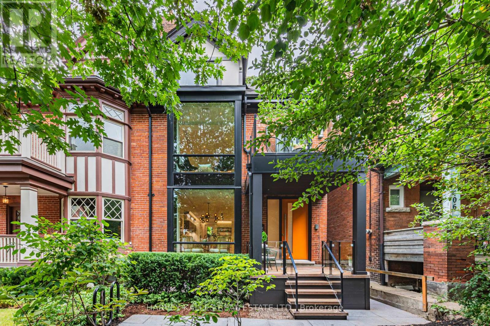 Located just steps from Bloor Street on one of the most desirable blocks in the Annex, this exquisite home is filled with nearly 3,800 Sq Ft of elevated, livable elegance. From the moment you enter, you're drawn through thoughtfully designed spaces with an architectural staircase winding through 4 levels. The open-concept main floor flows perfectly for both memorable entertaining & intimate gatherings with light that pours in from floor-to-ceiling windows. A culinary paradise in the sleek kitchen boasts integrated appliances, smooth countertops and a mix of high-gloss cabinetry & exquisite custom millwork. A warm, inviting sitting room beckons viewing parties with the TV feature wall & contemporary gas fireplace, illuminated by recessed lighting. Take a leisurely promenade via sliding doors to the newly-built deck with gas connection & garden terrace with fire table. Generous for central Toronto, there's tremendous potential in the verdant backyard. At the front of the 2nd level, a large suite features its own balcony & ensuite bath. There's no need to settle any sibling rivalries over who gets the best room with two delightful bedrooms that share a bathroom w/ double sinks; perfect for busy mornings. A hallway closet with rough-in for laundry offers added convenience to this family-friendly layout. The entire 3rd floor is dedicated to the serene Primary with 2 organized walk-in closets and a spa-inspired ensuite with heated floors, freestanding tub & separate WC for added privacy. Step out onto the oversized deck to take in leafy, panoramic views while unwinding in style. The fully finished lower level presents space for family activities, a home gym, plus a 5th bedroom & full bath. This turn-key home is replete with upgrades like built-in speakers & discreet switch-controlled window coverings in all of the principal rooms. Discover the best of the city by foot/bike with nearby parks, schools, world-class shopping, dining, museums & effortless access to the subway. (id:48254)