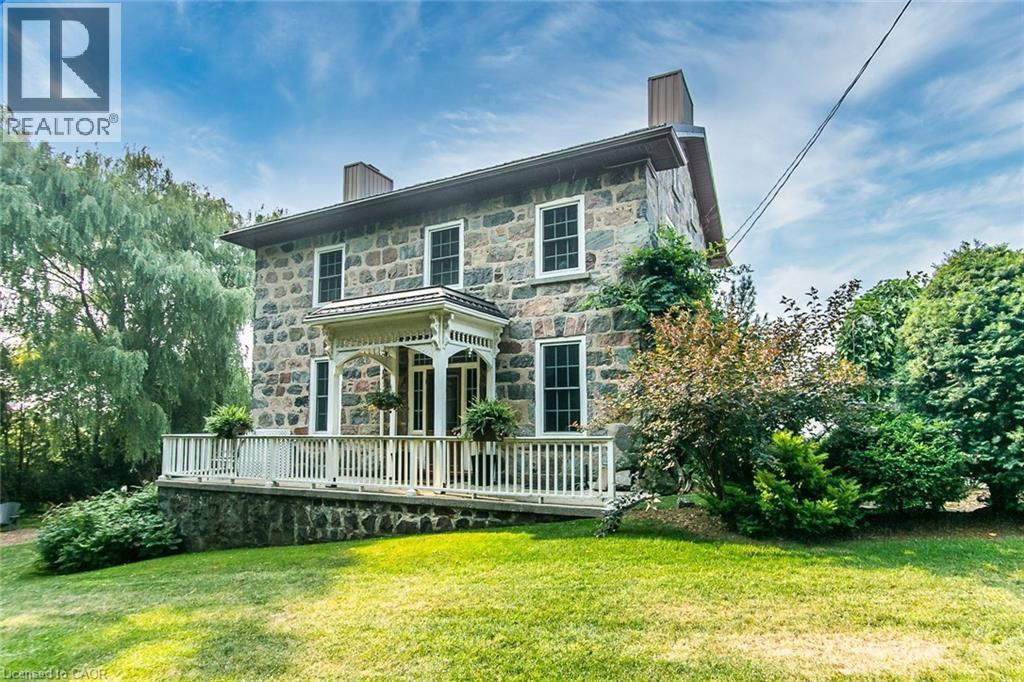 Welcome to your dream country retreat, tucked away on a peaceful rural road just outside Plattsville. This 1857 stone home has been renovated blending character with modern comfort, all nestled on a private, beautifully landscaped 1.6 acre lot that truly is a gardeners paradise. Stroll through the gardens, unwind by the firepit with family and friends. You'll find a charming shed, perfect for storing your riding mower, and other equipment. A sparkling 20x40 heated inground pool awaits you, tucked into its own secluded, fenced in area surrounded by mature trees and shrubs. There's even a dedicated vegetable garden for the green thumbs in the family. This exceptional home offers approximately 3700 sq.ft of living space, and a massive 4+car garage, featuring an E/V Charger, hot+cold running water, floor drains and portable heater. Two Breezeway entrances offer practical storage and convenience. Inside you will find formal Living/Dining rooms, perfect for family gatherings or quiet relaxation. The Gourmet Kitchen offers an abundance of cabinetry, granite countertops, a large island with Breakfast bar and high end appliances, and a new SS range hood. There is a spacious laundry/mud room, complete with ample storage. Off the Kitchen the outdoor Sunroom offers a perfect spot for movie nights, watching sports, etc. The bright Family room impresses with Cathedral ceilings, skylights, a cozy gas fireplace & a built-in wet bar. A loft area above adds even more versatile living space. Upstairs the Primary Bedroom is its own private retreat, featuring a large walk-in closet, luxurious 4pc ensuite with a walk-in shower, and cozy FP. 3 additional bdrs share a beautifully renovated 3pc bath. The partially finished WO Basement includes a wood FP & more storage. The Home is serviced by 2 wells, and a combination of Hot water gas heating, heat pump and ductless A/C Units. Hy-Grade roof(2016)This is truly a one-of a kind, must see Home. Just 30 mins to K-W. Book your private tour now. (id:48254)