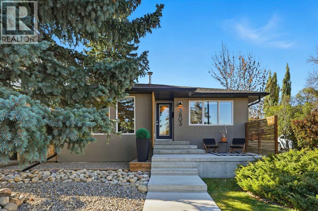 3803  16a Street Southwest  Calgary, Alberta Perfectly positioned across from Kiwanis Park in Altadore, this fully renovated vaulted bungalow pairs modern design with everyday comfort. The striking curb appeal begins with a modern façade, low-maintenance landscaping and a welcoming front patio shaded by mature evergreens. Inside, soaring vaulted ceilings and sunny skylights create a bright, airy living room anchored by a gas fireplace surrounded by clever built-ins and shelving. Oversized windows capture leafy park views, while built-in speakers add ambience for relaxing or entertaining. The chef’s kitchen impresses with sleek full-height cabinetry, a designer tile backsplash, gas stove, stainless steel appliances and a waterfall-edge island perfect for casual dining or conversation. A wall of glass frames the backyard and floods the space with natural light, connecting seamlessly to the adjacent dining area where patio sliders open to the west-facing deck for effortless indoor/outdoor living. The main level continues with a showstopping creative studio featuring exposed wood beams, custom lighting and generous workspace ideal for design, art or a home office. A comfortable guest bedroom enjoys park views, complemented by a stylish powder room. Downstairs, the family-friendly layout continues with a large recreation room designed for movie and game nights. The spacious primary retreat features a built-in closet system and a luxurious ensuite with dual sinks and an oversized rain shower. Two additional bedrooms, each with large windows, share a modern 4-piece bathroom. The beautifully finished laundry area adds thoughtful function with built-in storage and folding space. Outside, a massive west-facing yard invites outdoor enjoyment with a huge deck for barbeques, lounge areas for warm weather gatherings and plenty of grassy play space for kids and pets to play. Comfort is ensured year-round with central air conditioning, on-demand hot water, a high-efficiency furnace and a water softener. Set on a corner lot wi thin walking distance to River Park, Sandy Beach, and the boutiques and cafés of Marda Loop, this home embodies the best of Altadore living, design-forward, functional and outstandingly located! Open house Sat/Sun 12-2. (id:48254)