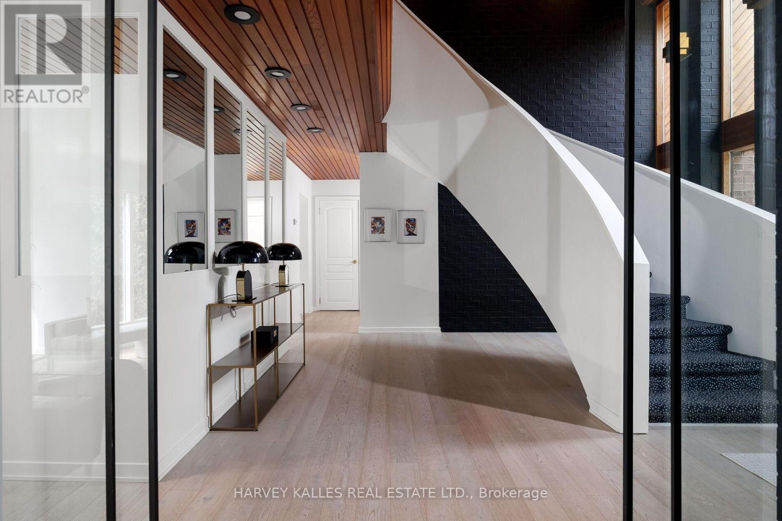 Say yes to the absolute best; this Markland Wood mid-century modern home is the pinnacle of style and comfort with unique details and a timeless aesthetic. Modern living and beautiful mid-century modern architecture? Check! Close to every amenity imaginable? You've got it! A beautiful backyard paradise on a ravine lot and an inground pool that makes you feel like you're on a tropical vacation every day, all day? Naturally. A brand-new mud room with direct access to the garage and side entrance? Oddly specific ask, maybe but yes, that too! Your new dream house offers so many perks that you may never need to board an airplane again. Designed by Award Winning Architect, Anthony Ferracuti (Global Architects), this 4+1 bedrooms, 3.5 bathrooms, plus a half bath home provides room to spare. The eat-in kitchen comes with professional-grade Frigidaire and Miele appliances, while a walkout basement makes entertaining a breeze, with its own kitchen, dining area, lounge spaces and sauna. Community features include Neilson Park Creative Centre, Markland Woods Golf Club, and walking/bike trails along the Etobicoke Creek Ravine (and CF Sherway Gardens, of course!) The home is also in the catchment area of top-rated schools, including St. Clement Catholic School. With an oversized pie-shaped lot, opportunities for outdoor enjoyment open up. This home was made for making memories. With an expansive primary bedroom complete with its own sitting area and a four-piece ensuite, it's hard to pick a favourite feature in this glorious oasis. This is your perfect home for everyday luxury. (id:48254)