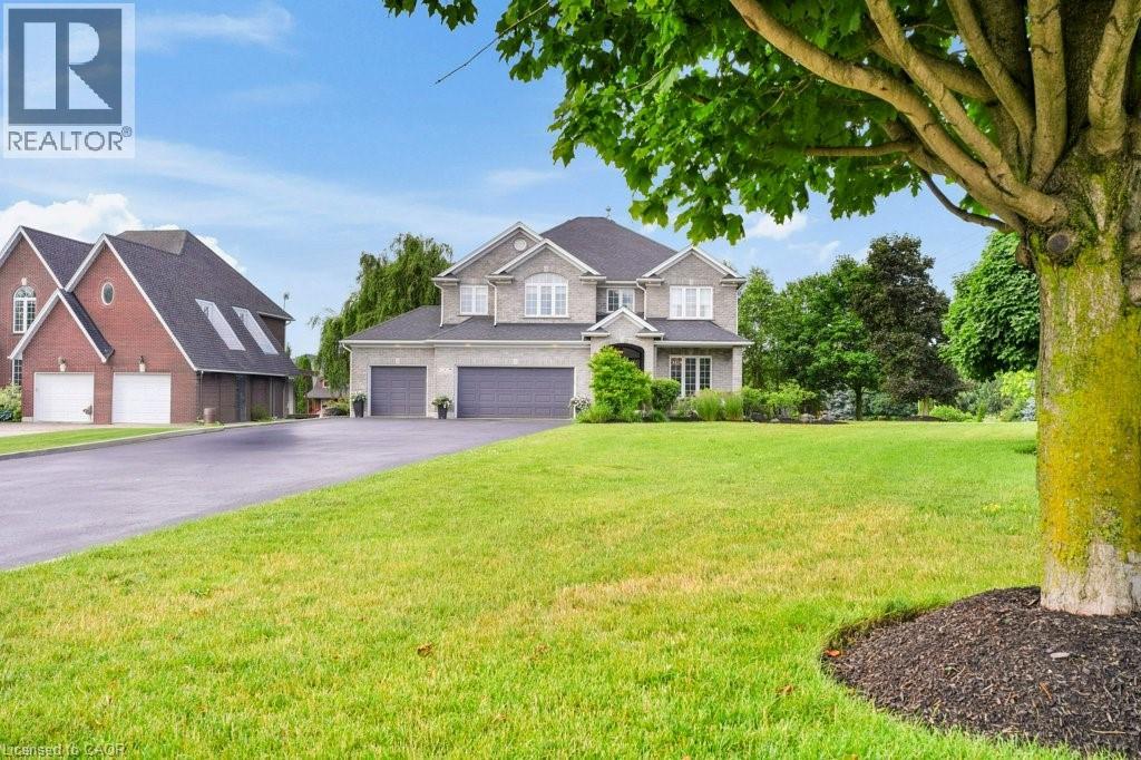 Experience the perfect blend of elegance & comfort in this beautiful estate, situated in the sought-after community of West Montrose. Designed with both style and function in mind, this home offers a thoughtfully planned layout creating an ideal setting for families of all sizes to enjoy. Main floor Captivates you with rich engineered hardwood flooring & premium ceramic tile throughout. At the heart of the home lies a true chef’s kitchen, featuring high-end appliances, granite countertops, undermount sink, & a professional 6-burner gas stove. The kitchen also includes two dishwashers, soft-close cabinetry, a built-in fridge, & two expansive islands, perfectly suited for everything from intimate family dinners to grand-scale gatherings. The five generously proportioned bedrooms each offer a private/semi-private bathroom. Large primary suite serves as a tranquil retreat, featuring a 4-piece ensuite & walk-in closet. Luxury upper level laundry room is located on this level. Step outside to a spectacular covered back porch complete with a wood-burning fireplace, built-in overhead speakers, heaters, & skylights. Stunning inground saltwater heated pool, creating a private oasis perfect for entertaining. Beyond the pool, a beautifully designed pool house offering a stylish space to enjoy. Complete with a full kitchen, a sit-up breakfast bar, a projection screen for movie nights, & a 2-piece bath & shower facilities. Landscaped gardens & mature trees create a picturesque retreat like setting. The fully finished lower level offers two bedrooms, 3pc bath, office space/play areas, & a large rec room. The home boasts a triple car garage, offering ample space for parking & storage. The enormous driveway provides parking for up to 16 cars.  And don’t forget, this home is equipped with surround sound & total home audio, provided by Station Earth, enhancing every room with exceptional sound. This is an extraordinary opportunity to make this one-of-a-kind property your own. (id:48254)