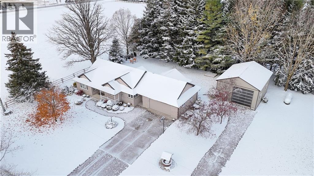 Welcome to this spacious country bungalow, perfectly set on a beautiful half-acre lot offering peace, privacy, and plenty of space to enjoy. This well-maintained two-bedroom home features a durable metal roof and a concrete driveway with a separate drive to the 25x32 ft insulated and heated shop. Inside, you’ll find a warm and inviting open concept home with a formal dining room, spacious eat-in kitchen, with walk out to a private deck, a comfortable family room, and bright living room, along with two full bathrooms on the main floor. The fully finished basement adds even more living space, complete with in-floor heating, a large rec room, extra bedroom, and craft room—perfect for hobbies or guests. There is high speed fiber internet available, which is rare in country living.  A major highlight is the fully metal lined 25’ x 32’ insulated and heated shop, also featuring in-floor heating, making it ideal for a hobbyist, mechanic, or home-based business.  This property is equipped with a back up generator.  The property provides plenty of parking, room for outdoor activities, and the quiet charm of country living, all while being easy to maintain. Whether you’re looking for space to work on projects, run a small business, or simply relax and enjoy the countryside, this property offers comfort, flexibility, and value. Don’t miss your chance to own this charming rural retreat. (id:48254)