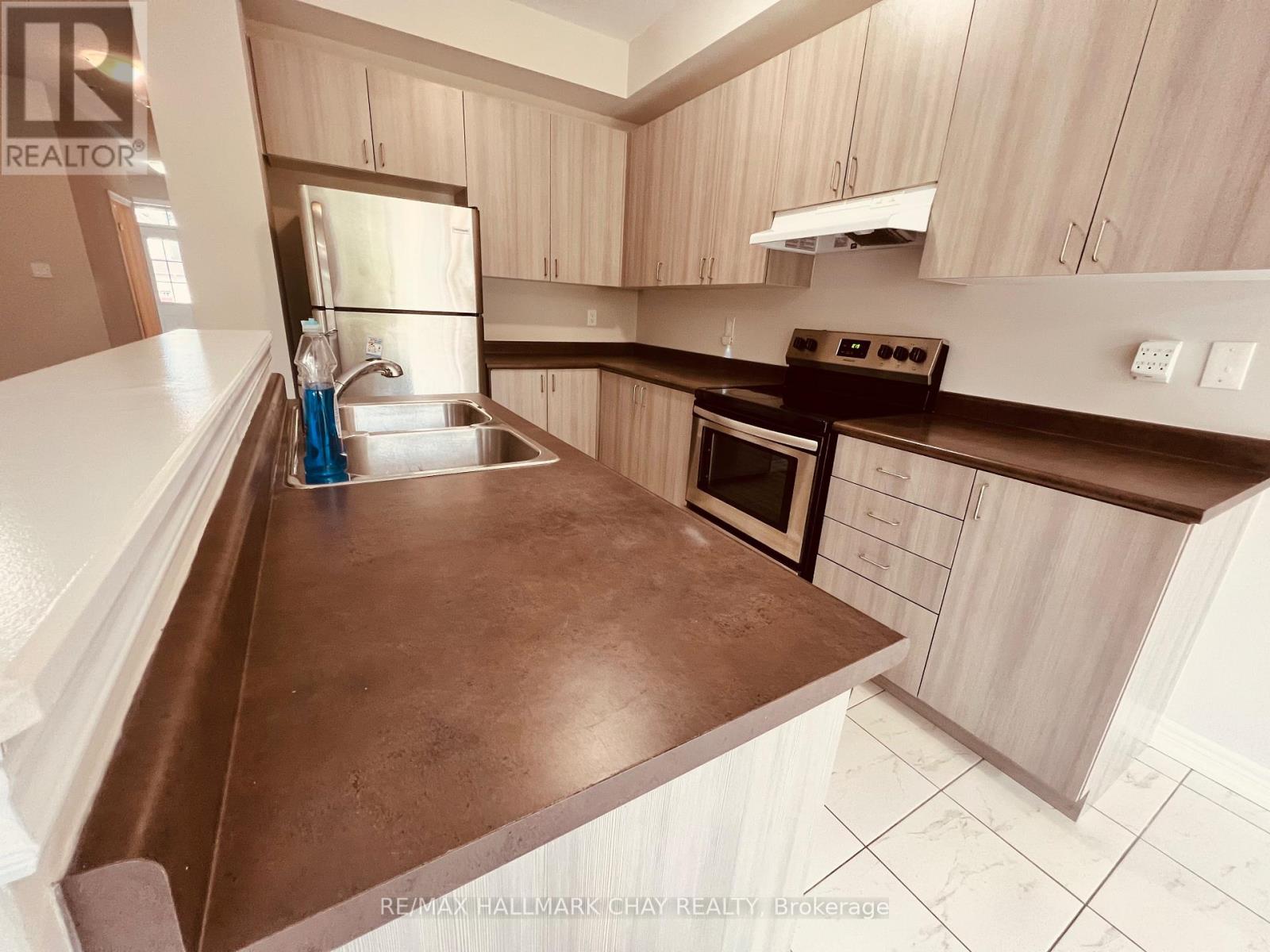 63 Greenwood Drive, Essa, Ontario  L0M 1B4 - Photo 4 - N12436046