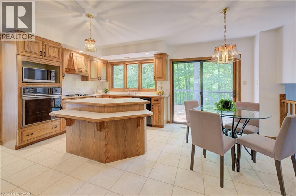 **OPEN HOUSE - Sun, Nov 30th, 2-4 pm.  Calling All Nature Lovers! A Rare, Private Retreat Backing Onto Tranquil Forest in Waterloo West! Welcome to your own forest-side oasis! Tucked away in one of Waterloo West’s most sought-after locations, this custom-built sidesplit offers over 4,700 sq ft of beautifully maintained living space—backing directly onto a peaceful, protected forest. Whether you're an outdoor enthusiast, empty nester, busy professional, or someone who simply craves peace and privacy, this property is a true sanctuary. Imagine stepping out to your private, wooded backyard with zero maintenance required—perfect for those who spend summers up north or love connecting with nature year-round. Direct access to nearby trails makes walking, jogging, mountain biking, or cross-country skiing a part of your everyday lifestyle. Lovingly cared for by the original family, the home blends timeless charm with modern comfort in a tranquil, tree-lined setting. Vaulted ceilings, expansive windows, and an open, airy layout create a warm and welcoming atmosphere. Recently painted throughout and featuring brand-new flooring, the home is move-in ready—yet offers room for personal touches and updates.  Upstairs, you’ll find four spacious bedrooms, including a serene primary suite with its own private balcony—perfect for your morning coffee or unwinding with treetop views.  The cleverly designed walk-up basement, excavated beneath the garage, offers soaring ceilings and oversized windows, creating a bright, flexible space ideal for a home theatre, gym, games room, or private retreat.  Step outside to a massive, newly built deck that spans the entire back of the home—an entertainer’s dream and the perfect spot to relax, dine, or simply soak in the sights and sounds of the surrounding forest. This is more than just a home—it’s a rare blend of privacy, space, and unbeatable location. You're just minutes from everything Waterloo has to offer, yet it feels like a world away. (id:48254)