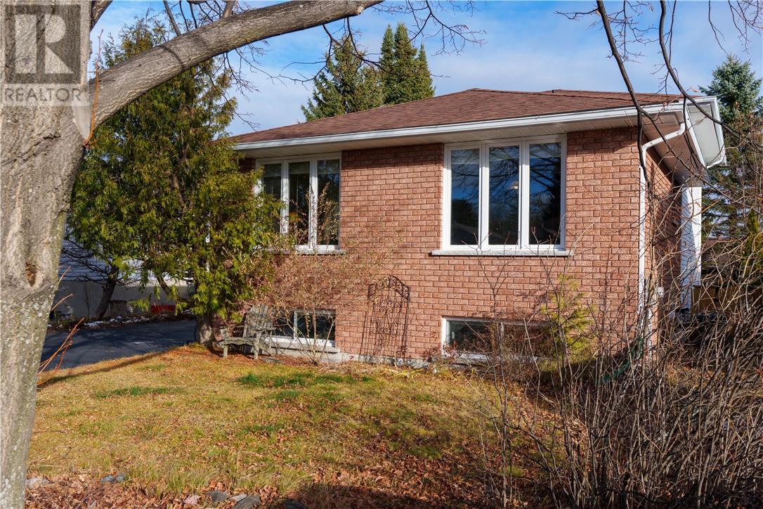 Welcome to 112 Ravina Ave — a spacious 5-bedroom, 2-bath home in the highly sought-after Ravina Gardens neighbourhood of Garson. This well-kept property offers versatile living space for a growing or multi-generational family, with thoughtful updates and pride of ownership felt in every room. Inside, you’ll find a welcoming living area highlighted by a beautiful wood stove set against a stone accent wall — the perfect spot to gather on cooler fall & winter evenings. The bright kitchen features ample cabinetry, modern appliances, and a spacious dining area ideal for everyday life and entertaining. Step outside to a peaceful, tree-lined backyard featuring plenty of space to unwind or play. Enjoy the best of both worlds: the convenience of city amenities just minutes away, paired with a sense of escape that makes every day feel like a getaway. Ravina Gardens: Where neighbours become family and nature is part of the address. (id:48254)