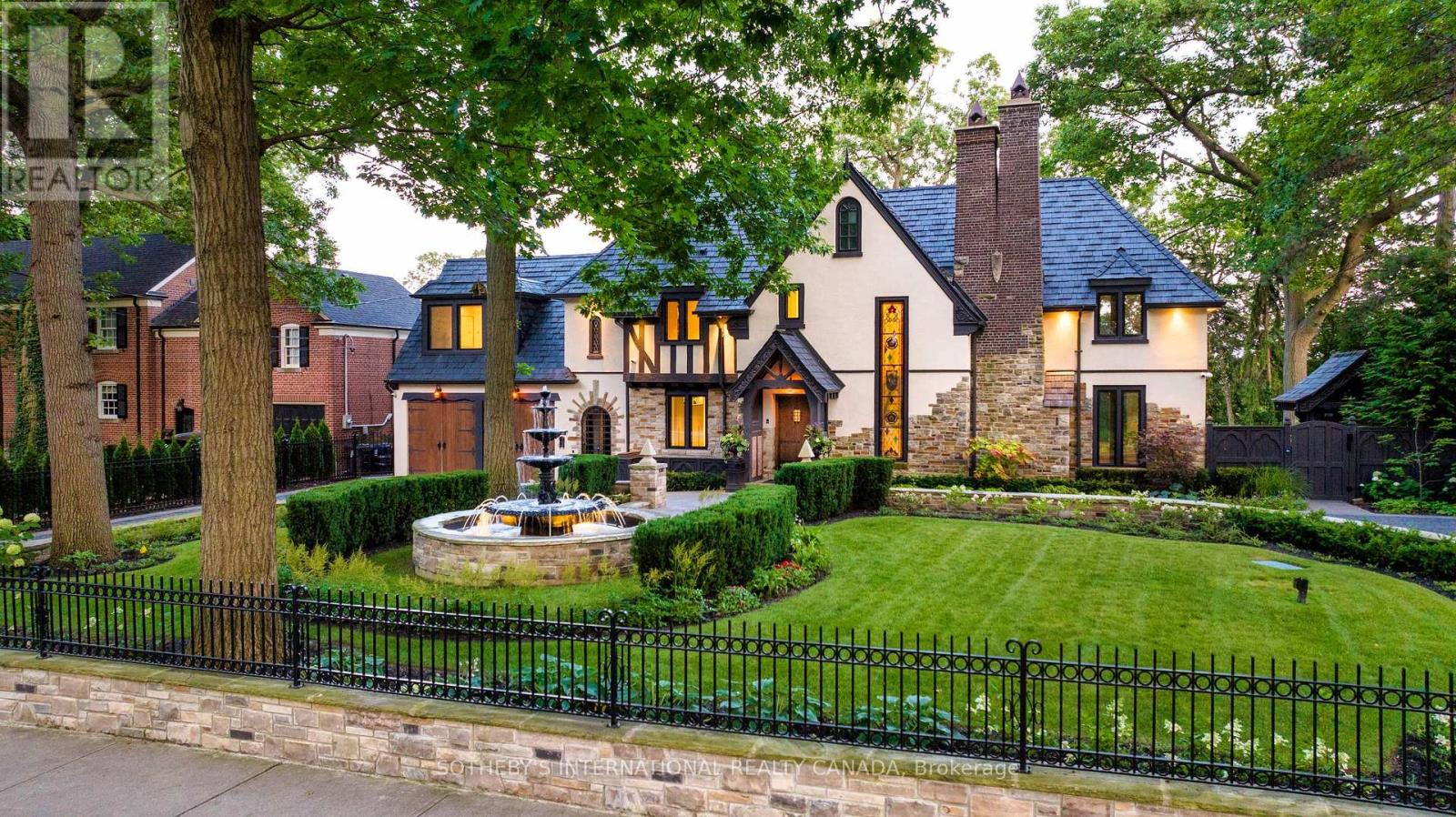 This stunning 1929 Tudor home has been meticulously transformed into a modern masterpiece, seamlessly blending historic charm with contemporary luxury and cutting-edge technology. Set on a sprawling 100' x 277' ravine lot, this $6 million renovation offers an exceptional living experience in one of Toronto's most prestigious neighborhoods. The grand exterior features a restored J.W. Fiske cast iron fountain and a heated cobblestone driveway, accommodating over 10 vehicles. Inside, every detail reflects craftsmanship and sophistication. The chef's kitchen, designed by Scavolini, is equipped with Wolf and Gaggenau appliances, while radiant-heated herringbone oak floors lead to floor-to-ceiling European folding glass doors that open to stunning ravine views. The spa-like bathrooms boast heated marble floors, European wall-mounted toilets, and custom millwork. Hidden HVAC systems, motorized blinds, and recessed lighting create a sleek, minimalist aesthetic. A state-of-the-art audio system, includes over 60 Bowers & Wilkins speakers, powered by Bryston, Sonos, and NAD amps. Four outdoor zones with buried subwoofers ensure exceptional sound across the property. The lower level is designed for entertainment, featuring 10' ceilings, polished concrete floors, a full-size arcade, a professional gym, and an indoor sauna. A walkout leads to a year-round heated pool, hot tub, and an all-season patio with infrared heaters, perfect for outdoor enjoyment in any weather. The home is fully equipped with app controlled automation for lighting, blinds, HVAC, security, audio, access, pool/spa/sauna. Residents enjoy access to the exclusive Baby Point Club, offering tennis, lawn bowling, and community events. A perfect blend of historic charm and modern luxury, this home offers an unmatched living experience. The home features a durable composite cedar roof with a lifespan of up to 60 years, offering long-lasting protection and timeless aesthetic appeal. (id:48254)