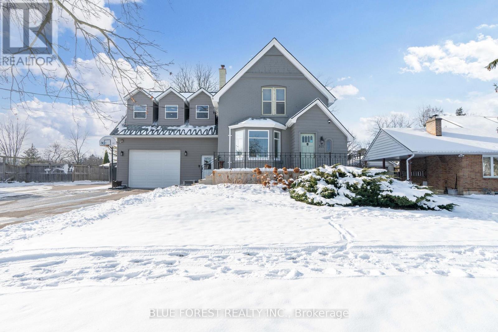 Welcome to 521 Upper Queen St., one of Highland's most remarkable homes situated on an impressive 70 ft x 200 ft lot with views of the 18th green at Highland CC. The home showcases timeless character with original hardwood floors, detailed millwork, and heritage features. A 1976 addition-updated with a stunning kitchen, dining, and family combined with the oversized attached garage addition (2021) ft. bonus rooms, has transformed this property into a highly functional, modern home! Inside, the living area at the front features a fireplace wall and an adjoining bonus room, perfect for a den. At the back, the updated kitchen boasts abundant cabinetry, an oversized island, stainless steel appliances, and wall-to-wall windows with peaceful views of the private, park-like yard. A powder room, laundry room, and large pantry add convenience. Upstairs, you'll find 4 bedrooms and 2 full bathrooms. The primary suite features cathedral ceilings, a full wall of windows with backyard views, a walk-in closet, and a 3-piece ensuite. The finished lower level offers a large rec room, bonus rooms, 3-piece bath, additional laundry area, and a partially finished bedroom with a new egress window, ideal for multi-generational living or rental potential. The oversized attached garage (2021) connects to the home via a bright mudroom hallway. Above and behind the garage are three finished rooms-perfect for offices, hobby spaces, guest suites, or a home gym.The sprawling backyard feels like a private park. Fully fenced with newer lower deck and framed by mature trees, including the rare Kentucky Coffee Tree! Offering privacy, shade, and views of the 18th green. Minutes from Wortley Village, Victoria Hospital, Highland Golf Course, and quick access to the 401, this historic, beautifully updated Highland gem is a rare find. (id:48254)