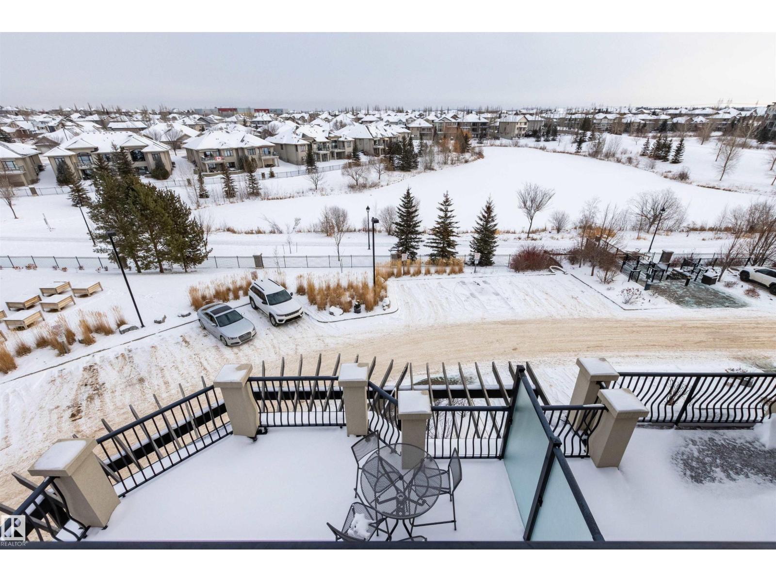 Rare opportunity to own this penthouse corner end unit with spectacular views off the balcony overlooking 2 lakes, landscaped trees, & walking trails!  This 2 bedroom + den open concept layout features; chefs galley kitchen, cherry stained mahogany cabinets, granite counter tops, s/s appliances, impressive 10' vaulted ceilings, engineered hickory hardwood, custom built-in murphy bed, den has built-in book shelf unit, ensuite off primary bed. has huge shower w/his & hers closets, in-suite laundry, spacious living rm w/corner mantle fireplace, formal dining rm., patio drs. lead to one of two covered private decks.  A truly remarkable gem in Mactaggarts exclusive neighborhood.  Best of all its an original owner & yes in showhome condition!  Complete with two heated underground stalls, one storage cage, two gyms, social rms., & Guest Suites!  Just minutes to Windemere, South Edmonton Common & Anthony Henday. (id:48254)