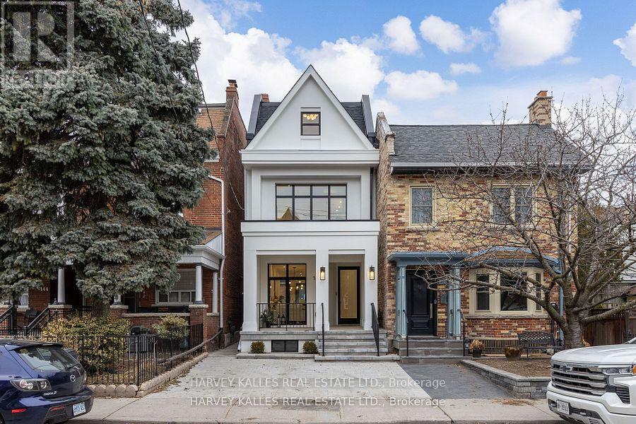It's not often a home of this caliber becomes available in the vibrant heart of Dundas & Ossington. This fully detached, three-storey residence is a masterclass in modern luxury! Tucked away on a quiet, tree-lined street, yet just steps from Toronto's most exciting restaurants, boutiques, and cultural hotspots. Thoughtfully reimagined from top to bottom, the home offers 3,195SF, including 2,335SF above grade & 860SF fully finished lower level. Every element is curated to the highest standard, from 10-foot ceilings and floor-to-ceiling windows to Italian marble accents including extremely elegant living room fireplace, custom millwork, Sonos-integrated in-ceiling speakers, and indirect mood lighting throughout. The custom kitchen features integrated Fisher & Paykel appliances and over 17 feet of built-in storage, leading to a powder room, mudroom, and walk-out to a fully fenced garden. Upstairs, three bedrooms include an incredible third-floor primary retreat with custom paneling, a private terrace with pergola, custom walk-in closet, and spa-like 5-piece ensuite bath. The finished lower level adds flexibility with a family room, fourth bedroom with 3-piece ensuite, in-ceiling speakers, tons of additional storage, and a laundry rough-in. Complete with a welcoming front porch, landscaped front yard, and parking for two, this exceptional home offers luxurious urban living in one of Toronto's most sought-after neighborhoods. (id:48254)