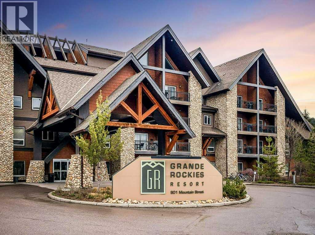 This 2-bedroom, 2-bath condo offers an efficient 692 sq. ft. layout and stunning mountain views of the iconic Three Sisters. Located in the desirable Grande Resort, you’ll love the easy walk to downtown shops, the river, and an extensive network of biking and walking trails. After a day of adventure, unwind in the indoor/outdoor hot tub, enjoy the indoor pool with waterslide, or let the little ones splash in the kiddie pool. On-site amenities, including a restaurant, spa, and fitness room create a complete resort experience, perfect for owners and guests to rest and recharge. The cozy living space features a gas fireplace for relaxing evenings and a covered deck where you can take in unforgettable mountain  sunsets. A rare opportunity, this unit shares a common foyer with its adjoining 1-bedroom neighbor (also available), allowing the potential to combine both into a 3-bedroom, 3-bath configuration. Zoned as a Tourist Home, the condo offers exceptional flexibility for short-term or long-term rentals, making it an ideal mountain retreat and investment. (id:48254)