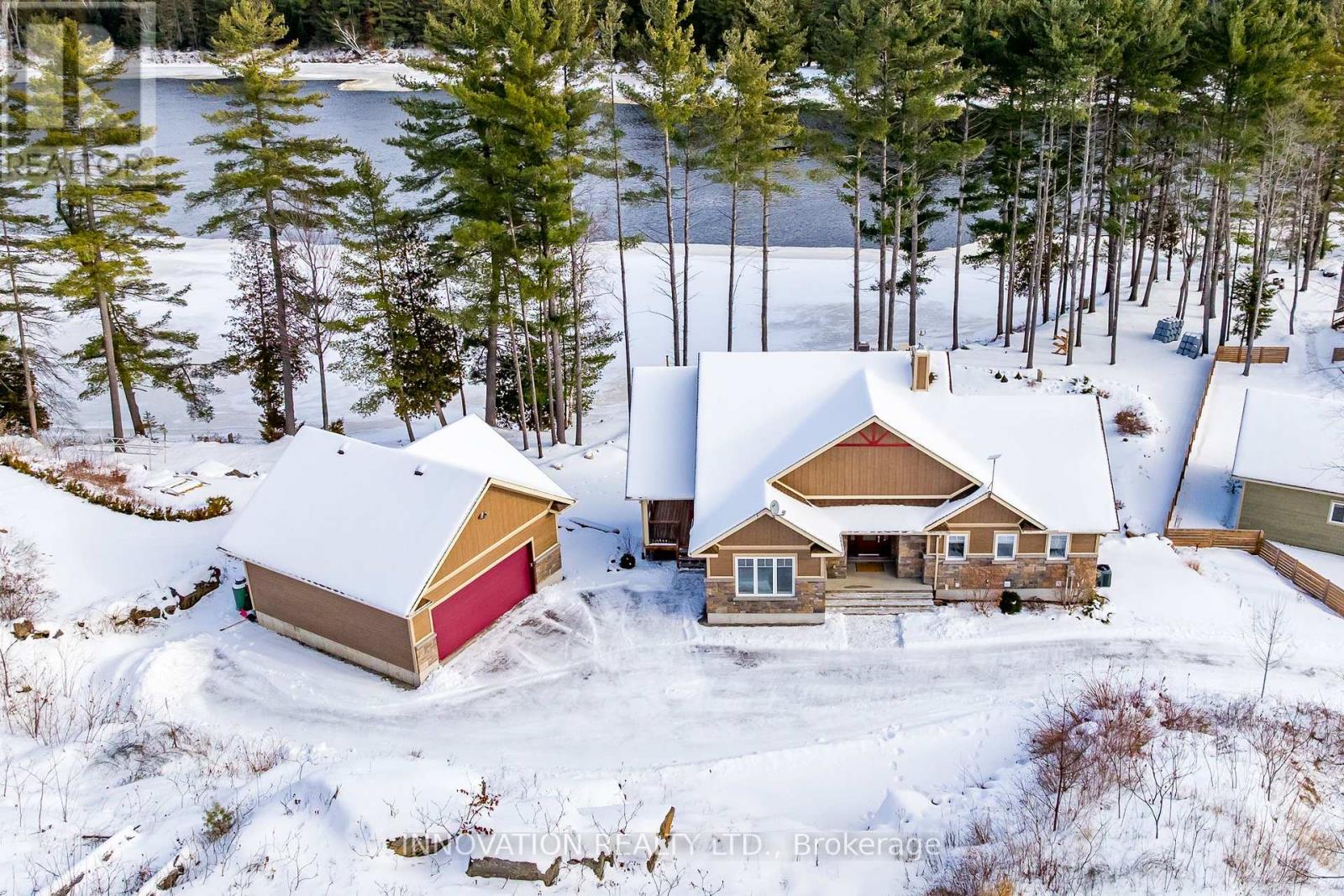 Discover a rare riverfront estate set along the tranquil shores of the Ottawa River. This custom-built 2019 bungalow offers 4 bedrooms, 3 bathrooms, and over an acre of beautifully landscaped grounds, framed by mature pines for exceptional privacy. Thoughtfully designed to balance elegance and comfort, the home seamlessly connects refined interiors with breathtaking natural surroundings. Inside, soaring vaulted ceilings and expansive windows capture panoramic river views and flood the open-concept living space with natural light. The chef's kitchen is both stylish and functional, featuring high-end appliances, a large island, a walk-in pantry, and a reverse osmosis system-ideal for daily living and effortless entertaining. The primary suite is a private retreat with serene water views, balcony access, and a spa-inspired ensuite complete with a glass shower, deep soaker tub, and dual vanities. A second bedroom on the main floor adds flexibility, while the walkout lower level offers radiant floor heating, two additional bedrooms, a custom recreation area, and direct access to the backyard. Every detail has been carefully considered, from the well-appointed laundry room with granite counters and custom cabinetry to modern conveniences including motorized blinds, programmable thermostats, central air, Lifebreath air exchanger, and a full HD security system. An oversized detached heated garage provides ample space for vehicles, storage, or a workshop. Outdoors, the property becomes a true oasis. Enjoy year-round relaxation in the screened spa lounge with hot tub, gather around the fieldstone firepit, or head to the floating dock for boating, kayaking, and exceptional fishing, an angler's paradise. Additional features include an irrigation system, cedar kayak rack, and a charming hobby garage. This is more than a home; it is a refined waterfront lifestyle offering privacy, comfort, and timeless natural beauty. (id:48254)