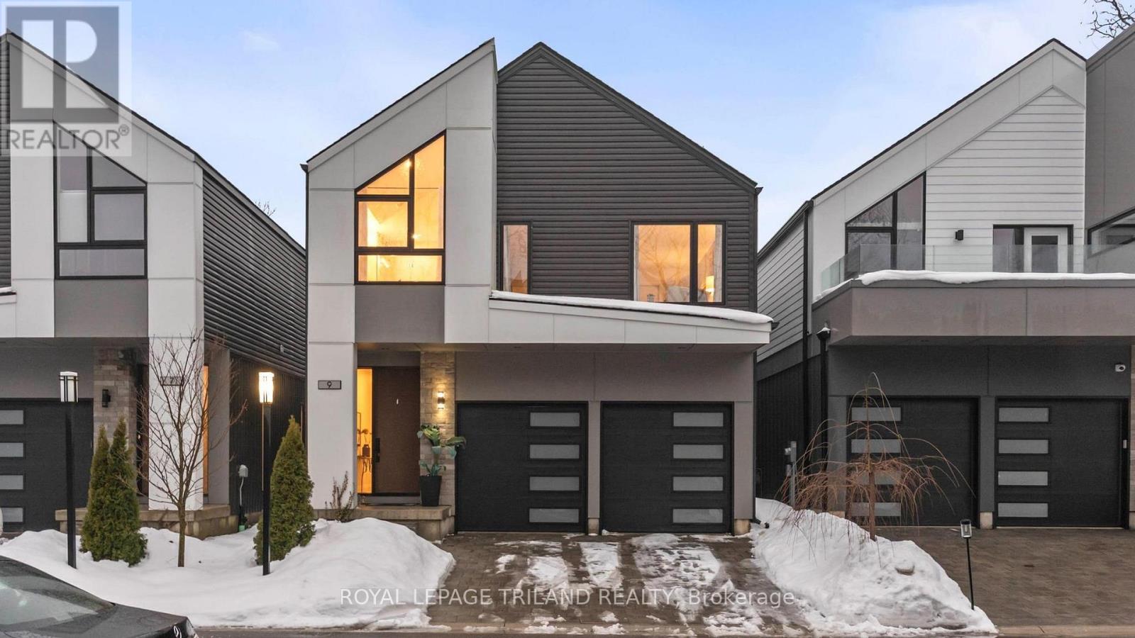 Discover refined contemporary living in this stunning 3-bedroom, 2.5-bath, two-storey executive home offering approximately 2,123 sq. ft. of thoughtfully designed living space. Built just five years ago, this home blends modern architecture with elevated finishes, abundant natural light, and a layout that flows beautifully for both everyday living and entertaining. Step inside to an open, airy main level highlighted by rich engineered hardwood flooring. The chef's kitchen is truly the heart of the home, featuring a striking waterfall island with seating, generous counter space, abundant drawer storage, and stainless steel appliances. Whether hosting a dinner party or enjoying a casual night in, this kitchen is designed to both impress and perform. The main living areas are flooded with natural light, creating a warm and welcoming atmosphere that complements the home's clean, modern lines. Thoughtful storage solutions throughout help keep the space organized, functional, and effortlessly stylish. Upstairs, the spacious king-sized primary retreat offers a private sanctuary. This expansive suite features a large walk-in closet and a spa-inspired 5-piece ensuite with sleek tile, a freestanding soaker tub, glass-enclosed shower, dual vanity, and a separate water closet for added privacy. Two additional bedrooms are generously sized and versatile-ideal for family, guests, or a home office. The convenience of an upstairs laundry room further enhances the home's executive appeal. Outdoor living is equally inviting. Step onto the deck overlooking the fully fenced, spacious backyard-perfect for summer entertaining, kids at play, or simply relaxing in a quiet, private setting. Nearby walking trails offer easy access to nature and recreation, adding to the home's lifestyle appeal. With its modern design, quality construction, upscale finishes, and excellent use of space, this move-in-ready executive home offers a rare opportunity to own a nearly new property without compromise. (id:48254)