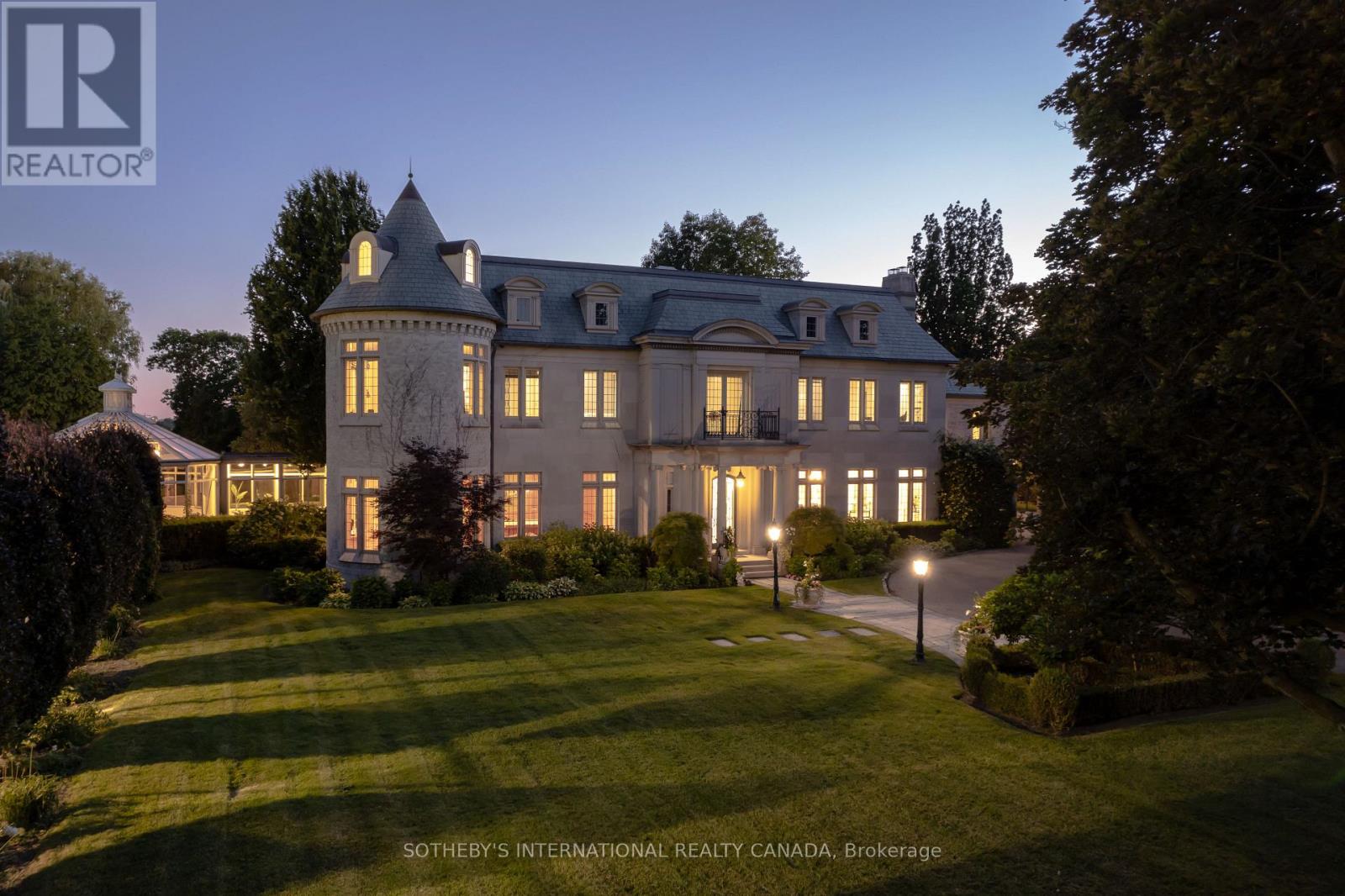 Arguably one of Torontos most iconic estates, this French-style chateau is an extraordinary expression of European grandeur on a 3.12-acre double lot in the prestigious enclave of Bayview Ridge. Designed by renowned architect Gordon Ridgely, the residence commands unobstructed western views over the Rosedale Golf Club. Beyond the stately stone gates and circular drive, manicured gardens by Ron Holbrook frame a breathtaking setting featuring a negative-edge infinity pool, a reflecting pond with a stepped waterfall, tennis court, kitchen gardens, flagstone terraces, and a stone cabana. The striking facade spans nearly 150 feet, clad in Indiana buff limestone and rubble stone with Vermont unfaded green slate shingles and lead-coated copper details. An ivy-clad turret anchors the asymmetrical design, lending the home its signature silhouette. Inside, over 15,000 square feet of living space showcases Brazilian cherry wood floors with African wenge inlay, acid-etched antique Crema Marfil marble, coffered ceilings, Indiana limestone fireplaces, and solid North American cherry doors. Six principal bedrooms and two additional suites are complemented by ten baths and warm, richly detailed interiors. The main floor features an impressive library and office with wood-burning fireplace, a grand dining room with artisan-painted walls and ceilings, a conservatory beside the spacious family room, and a sunlit morning room perfect for coffee. Three staircases, including a hidden passage, lead to the lower level with a Bordeaux-inspired wine cellar, cigar room, gym, nanny suite with two bedrooms, a full kitchen, and a large recreation space. Upstairs, the primary suite offers a six-piece spa bathroom, dual dressing rooms, gas fireplace, and sweeping views. Each bedroom enjoys an ensuite bath and sitting area, blending luxury with practicality. This remarkable estate is a once-in-a-generation offering at once grand, intimate, and built to endure. (id:48254)
