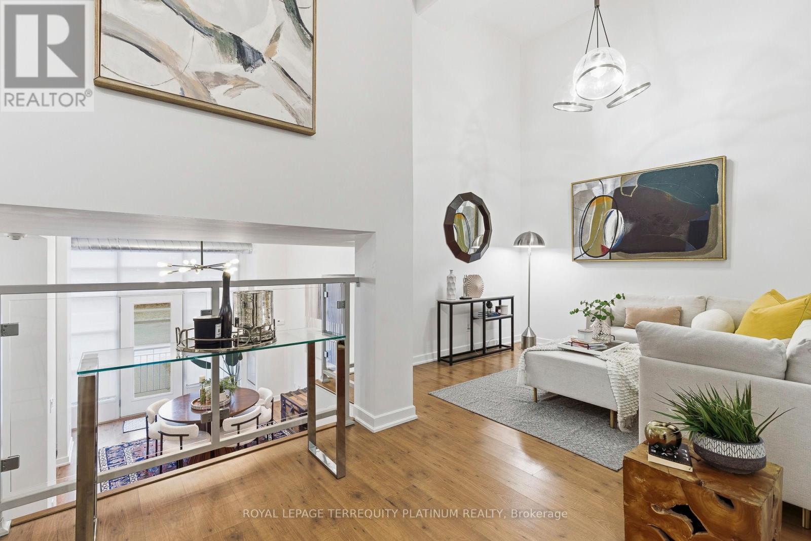 Welcome to a truly special three-storey condo loft that seamlessly blends the convenience of direct street access with a creative and airy layout designed for elevated living. From the moment you enter, soaring 14-foot ceilings in the main living space create a striking sense of openness and architectural interest. Enjoy iconic CN Tower views from the ground-level area and the upper bedroom, bringing a distinctive Toronto skyline to everyday living. Thoughtfully designed as a two-bedroom plus den suite, the versatile den is ideal as a home office or can easily be converted into a third bedroom, complete with its own closet space. Ideally located close to the condo amenities on the first floor, and just steps from the elevator, the unit offers quick access to underground parking and storage, where the large walk-in storage room (9'10" x 8'6") is conveniently beside the parking spot. Residents enjoy well-maintained common areas, including bike storage, party room, media room, gym, and a rooftop garden with BBQs offering stunning views of majestic Casa Loma. Moments from Dupont Subway and surrounded by boutique shops, cafés, and fine dining, this professionally painted, cleaned, move-in-ready home delivers a refined urban lifestyle best experienced in person. 3D Tour & Video Available. Book your private showing today. (id:48254)