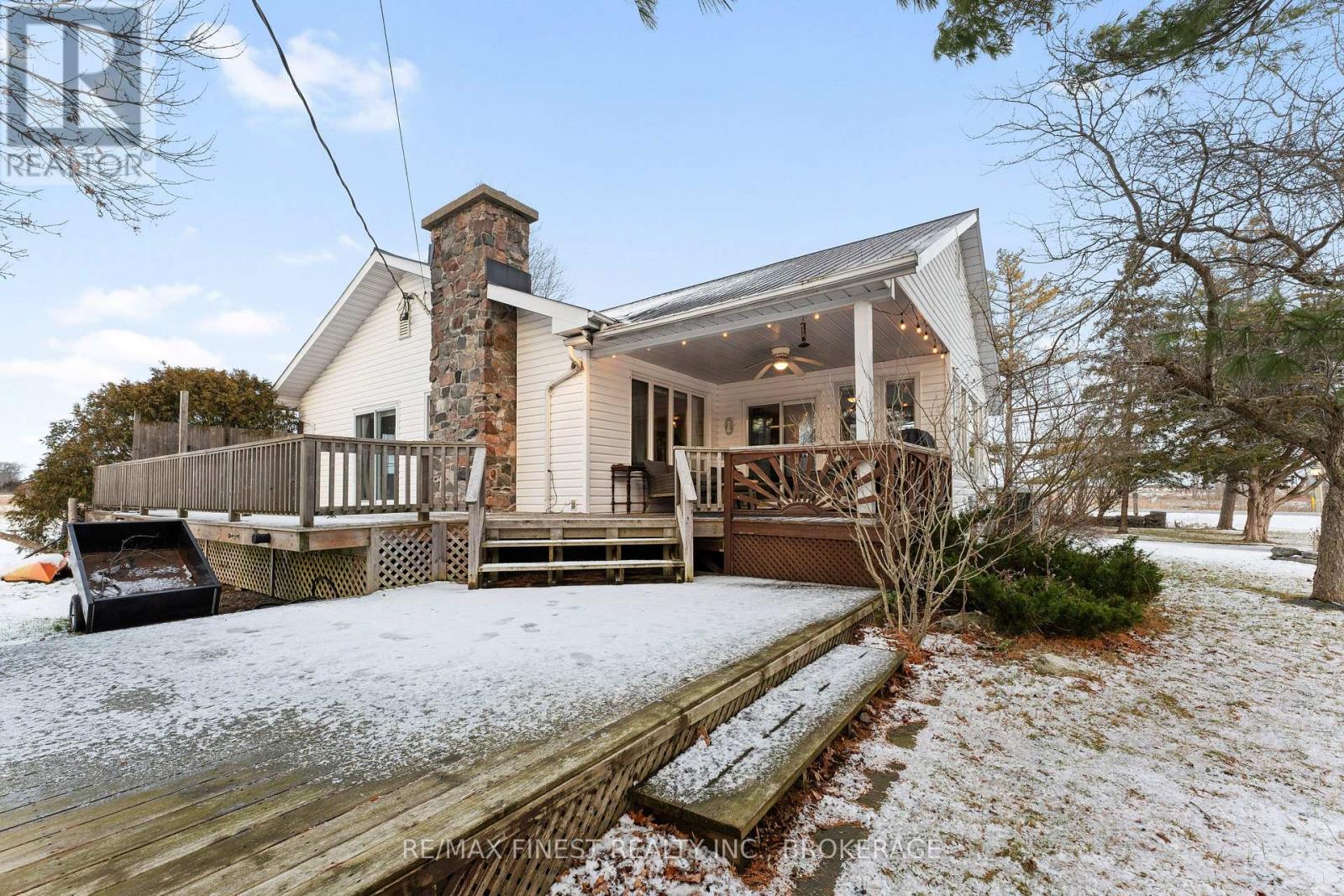 Nestled on a picturesque one acre lot just outside the charming village of Bath, Ontario, this exceptional 3 bedroom, 1.5 bathroom home is a blend of history, comfort, and modern updates. A true testament to craftsmanship, the home boasts original woodwork trim, lovingly milled from trees on the property, infusing warmth and character into every room. Inside, you will find updated flooring and perfectly selected wall colours that enhance the inviting ambiance. The finished basement provides additional living space, ideal for a family room or home office. Cozy evenings await by the stunning fieldstone chimney, a focal point of the living area. The exterior is just as impressive, featuring a durable steel roof and updated windows for energy efficiency. Enjoy the seasons on the expansive covered porch or entertain on the large deck overlooking the lush property. With new heat pumps providing efficient heating and cooling, comfort is guaranteed year round. Practicality meets charm with ample parking, a handy shed, and the peaceful setting just minutes from Lake Ontario. This home offers the perfect retreat while keeping you connected to the quaint amenities of Bath. Don't miss the opportunity to own a piece of this beautiful area! (id:48254)