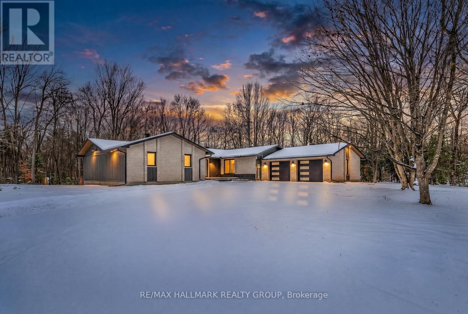 Nestled on a picturesque 2 acre lot, this beautifully updated bungalow offers a rare blend of privacy, serenity, and convenience. A gentle stream winds its way through the property, framed by mature forest that provides year round natural beauty and a sense of seclusion, all while keeping outdoor maintenance to a minimum. Built in 1988 but extensively updated, the home feels brand new, with nothing left to do but move in and enjoy for years to come. A curved paved driveway leads to the welcoming front patio and entryway. Inside, the open-concept design immediately impresses, with the living room, dining area, and kitchen flowing together in a bright, airy space that overlooks the forest. Every season brings a new view, turning the landscape into a living work of art. The main floor features 3 generously sized bedrooms and 3 bathrooms, including a luxurious principal suite. The main level also includes a den/office, a practical laundry room, and a powder room. The lower level is equally impressive, with a spacious finished basement that provides endless possibilities. A full bathroom, large workshop/hobby and storage room make this area ideal for projects. Perfectly sized for those who want to downsize without sacrificing comfort, this bungalow is a haven for nature lovers who appreciate tranquility and privacy, yet still want to remain close to shopping and everyday amenities. With its thoughtful design, modern updates, and idyllic setting, it offers the best of both worlds: the peace of country living and the convenience of city access. (id:48254)