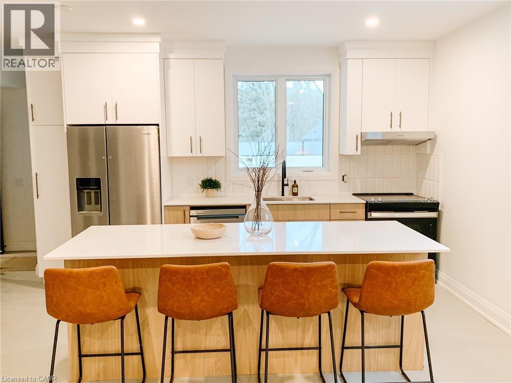 Welcome to Suite 102 at the 150 Alma Luxury Apartments in the heart of Rockwood. Suite 102 offers a spacious layout with 2 bedrooms & 1.5 bathrooms. Meticulously designed, this accessibility friendly suite has a barrier free entrance and pathways & widened doorways and hallways. Finished top to bottom with elegant finishes, designer kitchen & bathrooms, heated polished concrete flooring, smart home technology and a private patio. The designer kitchen is equipped with accessibility friendly stainless steel appliances, quartz countertops and custom cabinetry. The primary bedroom features a 3 piece ensuite. This suite is complete with 1 parking space. Simply move in and enjoy a worry-free chic lifestyle! (id:48254)