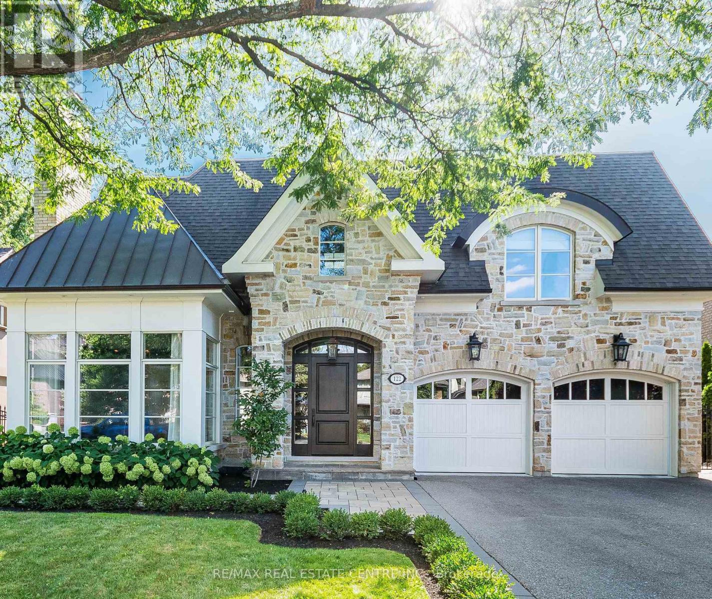 Modern masterpiece in prestigious Humber Valley!! Welcome to 122 Wimbleton Road, an architecturally stunning custom residence nestled in the heart of Toronto's exclusive Humber Valley. Designed by renowned architect David Small, this bespoke 4+1 bedroom, 5-bathroom home offers over 6,000 square feet of exceptional living space, masterfully blending modern West Coast elegance with seamless indoor-outdoor living. Located within a top-tier school catchment, this home is just a short walk to some of Toronto's most sought-after public, private and Montessori schools, making it ideal for families seeking elite education in a prime location. Custom Sapele Mahogany front door leading to dramatic foyer with soaring 20ft. ceiling and radiant natural light. 10ft ceilings on the main level and 9ft on the upper and lower levels. Quarter-sawn white oak flooring on the main and upper levels with hand-scraped hardwood in the lower level. Gourmet kitchen by Marcon featuring Wolf, Sub-Zero and Miele appliances. Walls of glass open to a Serene backyard oasis with a 16x32x8ft saltwater pool w/waterfall, outdoor gas fireplace and TV. Spa-inspired primary ensuite with 1" water line, Aqua brass fixtures and heated floors. Radiant heated lower level with glass-enclosed gym and custom wine cellar by Rosehill. ELAN smart home automation: whole-house A/V, lighting, security and intercom. Designer lighting and Hunter Douglas blinds throughout. Crafted with integrity and artistry - reclaimed brick from a historic church, Golden Brand wood windows and meticulous wood sheathing - this residence is both a work of architecture and a home of enduring warmth (id:48254)