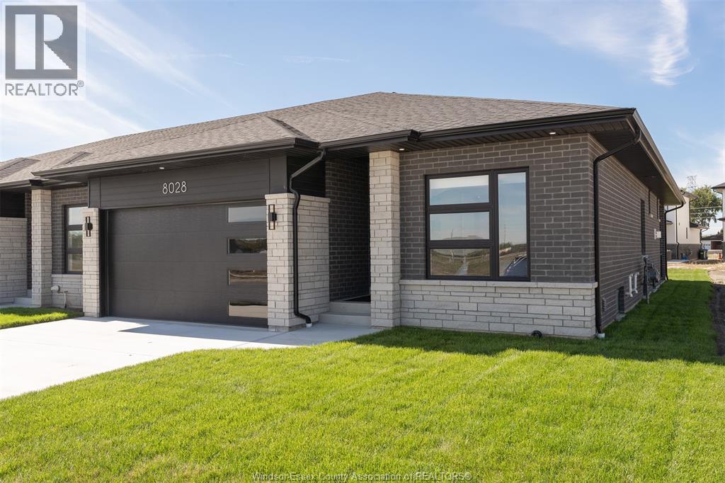 Welcome to 8028 Meo Blvd in Silver Leaf, LaSalle’s premier development, ideally located just minutes from Highway 401 and the U.S. border. This 1 year end-unit ranch townhome offers additional windows for enhanced natural light and a thoughtfully designed open-concept layout. The main floor features two spacious bedrooms, two full bathrooms, and a bright living area highlighted by a gas fireplace. The upgraded kitchen includes quartz countertops, premium cabinetry, and an oversized island, flowing seamlessly into the dining area with large patio doors leading to a covered outdoor space. Convenient main-floor laundry completes the level. A grade-level entrance provides excellent future potential for an ADU or in-law suite. Quality upgrades throughout construction include hardwood flooring, tile, upgraded kitchen cabinetry, and a large island. All new appliances are included. Enjoy a highly walkable lifestyle with scenic trails nearby, as well as a short walk to a newly developed commercial centre featuring Tim Hortons, Shoppers Drug Mart, Food Basics, McDonald’s, and more. Close to schools and everyday amenities. Flexible possession available. (id:48254)