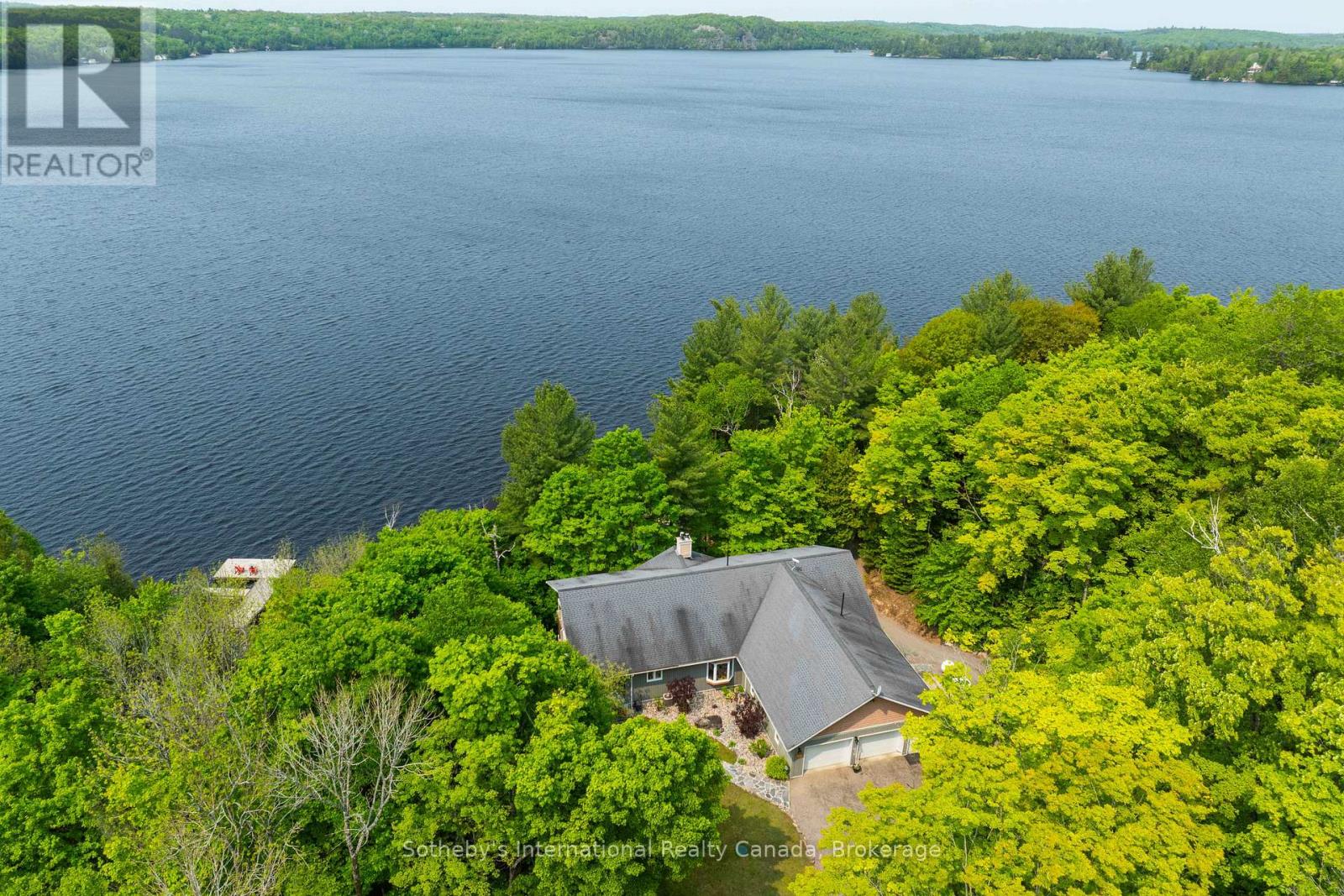 Built in 2008, this energy-efficient ICF block bungalow with walk-out basement offers year-round comfort. Situated at the end of a dead-end road provides privacy on this irregular 1-acre lot. Lake front property with the desirable southwest exposure of Lake Cecebe, a lake that offers 40 miles of boating joining Lake Cecebe with the Magnetawan River, Midlothian Lake and Ahmic Lake. Perfectly placed in between Burk's Falls and Magnetawan and just 30 minutes from Huntsville. The main floor of the home features hardwood/tile floors, a custom chef's kitchen by Cutter's Edge of Muskoka made of solid hickory including extra touches such as two sinks and Corian countertops. Open concept from kitchen, dining and living room provides the perfect space for entertaining your family and friends. The living room has vaulted ceilings and a grandeur granite stone gas fireplace. A deck off each side of the living room provides extra living space for outdoor dining and relaxation. Main floor primary bedroom has a walk-in closet, ensuite with double sinks, walk-in shower and heated tile floor. A pantry provides extra storage and a place for a freezer. The laundry room on the main floor shares a mud room coming in from the 2-car 30' x 30' garage with work bench. An added touch is the 2-piece washroom with a work sink in the garage. To complete this level is a second bedroom facing the lake. The lower level has 2 spacious bedrooms with closets, 3-piece washroom with heated tile floor. The family room has a Napolean wood burning stove, entertainment centre and a shuffleboard table. There is a wood room on this level for easy access to the wood or it can be easily converted to another bedroom. To continue with convenience, there is a kitchenette on this level equipped with a refrigerator, microwave, cupboards and sink for easy cleanup. Relax in an indoor hot tub that has a sliding door to the outdoors or convert to an office, bedroom or gym. Walk out to a deck which leads you to the lake. (id:48254)